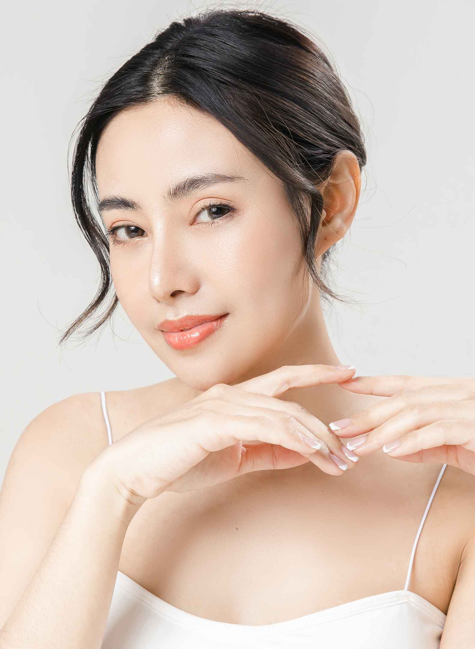 Asian woman smirking at the camera