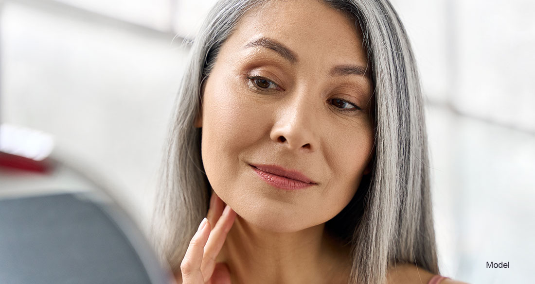 Woman touching her neck with one hand